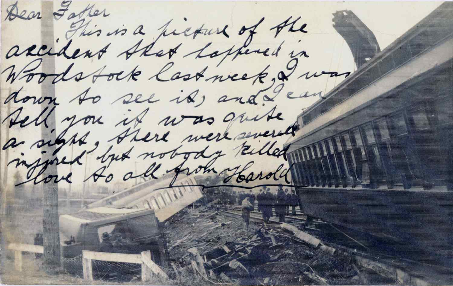 A photo of the Lehigh Express train derailment. The train cars are off of the tracks. Some of the wreckage is laying beside the train A small group of men is standing near the train. A letter is written over the photo. 