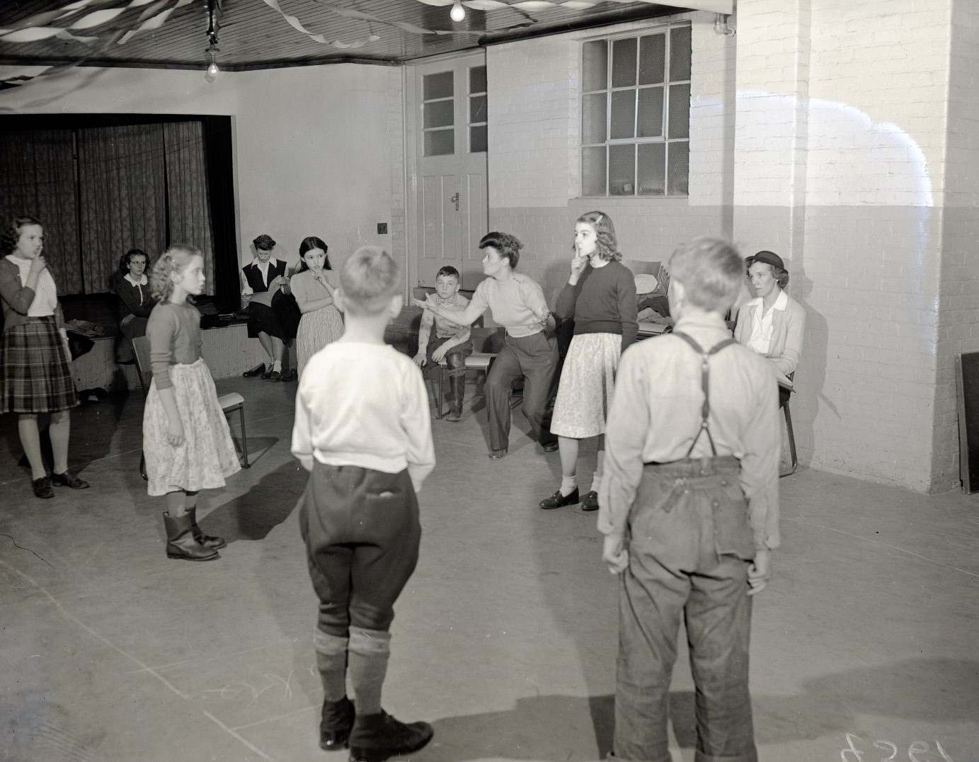 Children standing in a circle preparing for a game.