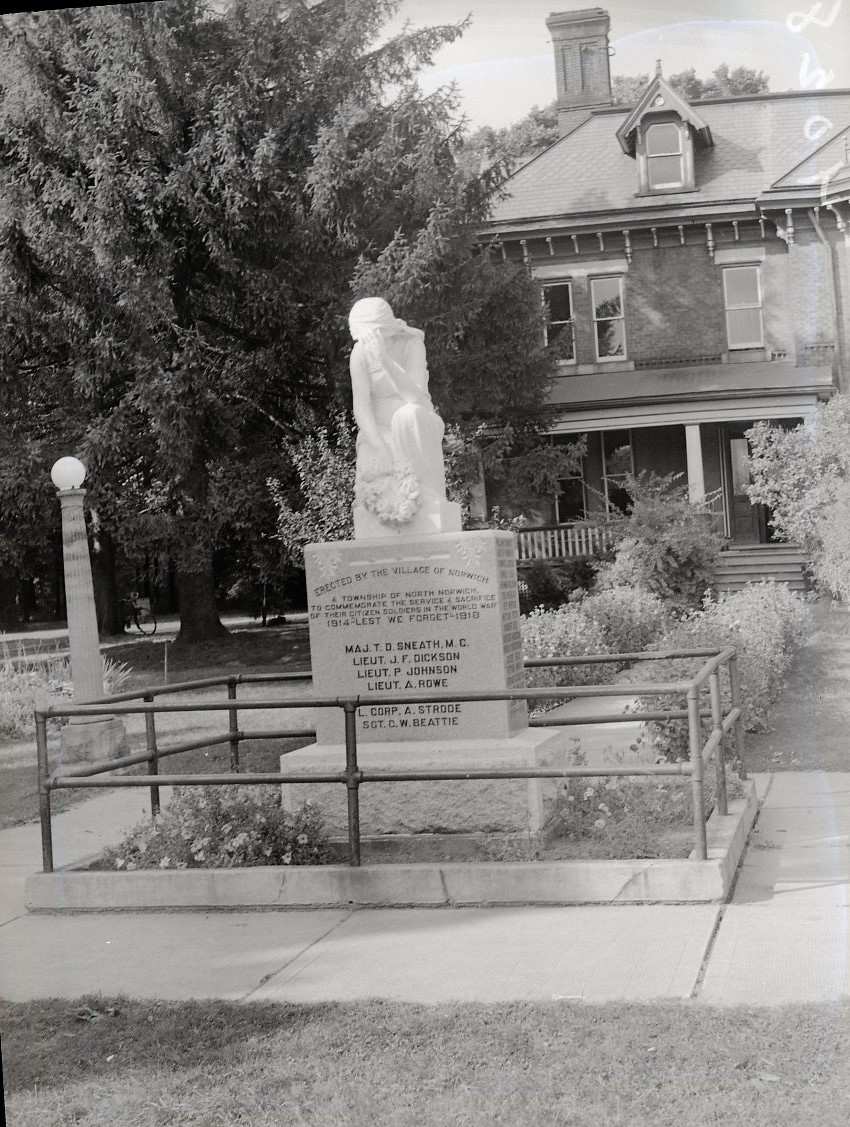 Norwich, Ontario cenotaph featuring a marble statue of a woman weeping.