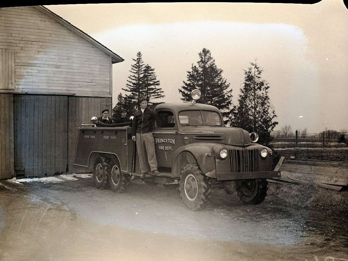 Men posing around the Princeton fire truck.