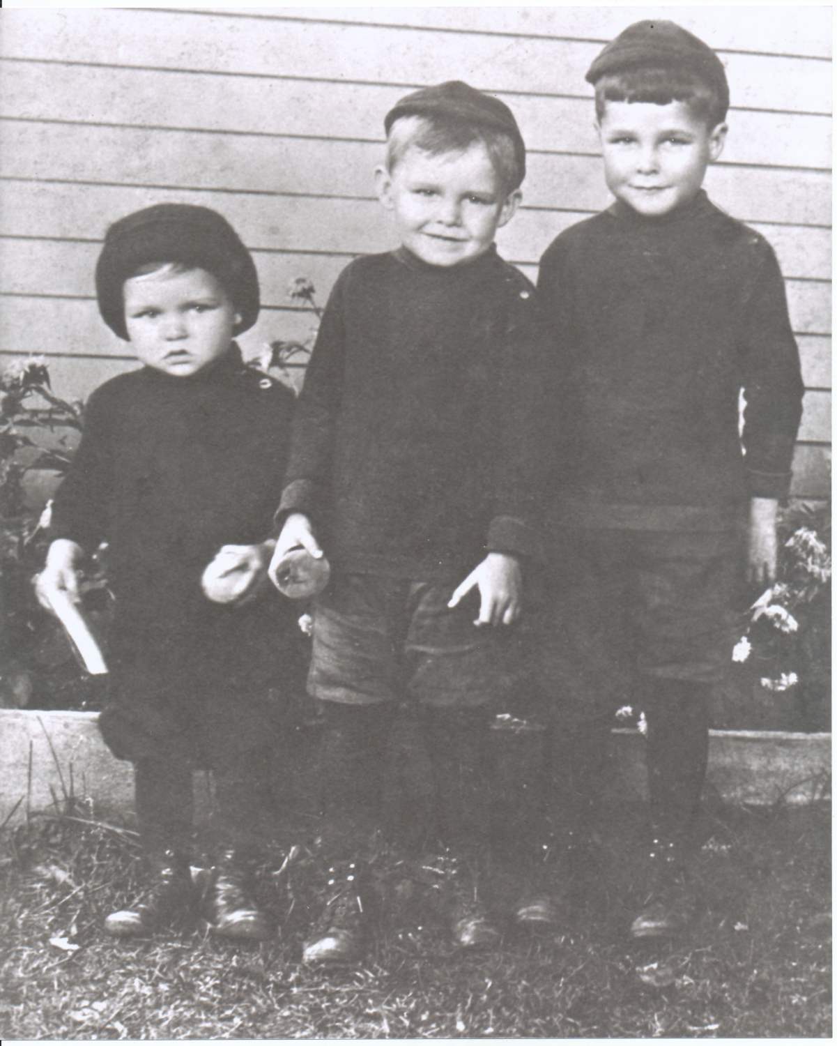 Ed Bennett with his brothers as children. The boys are wearing sweaters and hats.