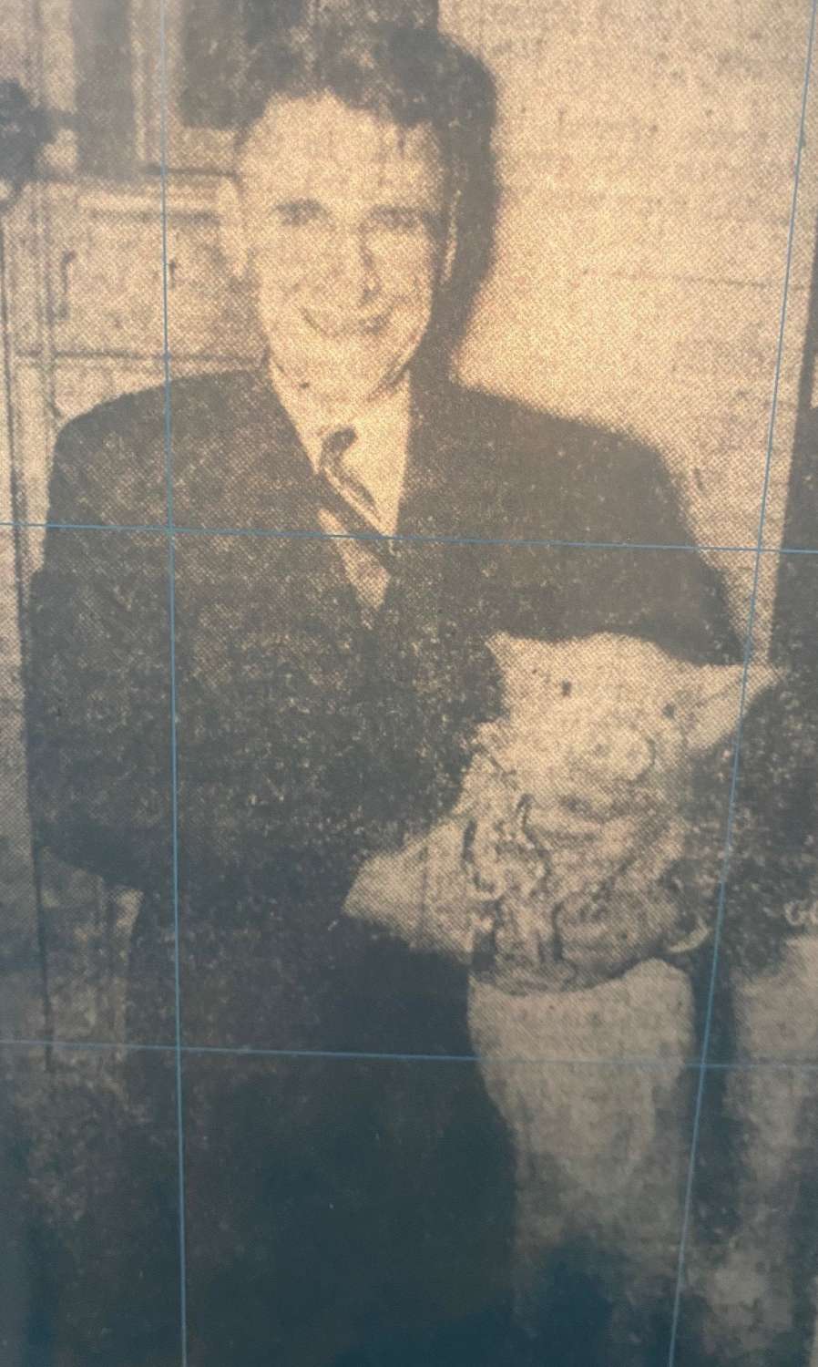 Hugh Harris holding a pig.