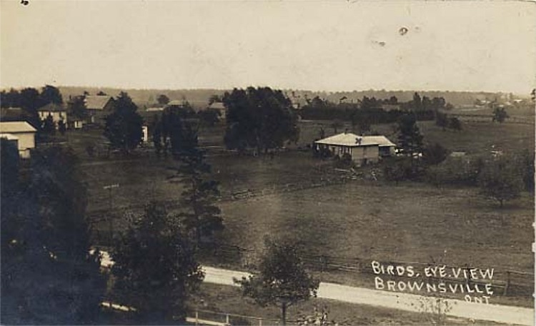 A bird's eye view of Brownsville, Ontario. Trees spot the scenery, and in the centre of the image a a small frame building.