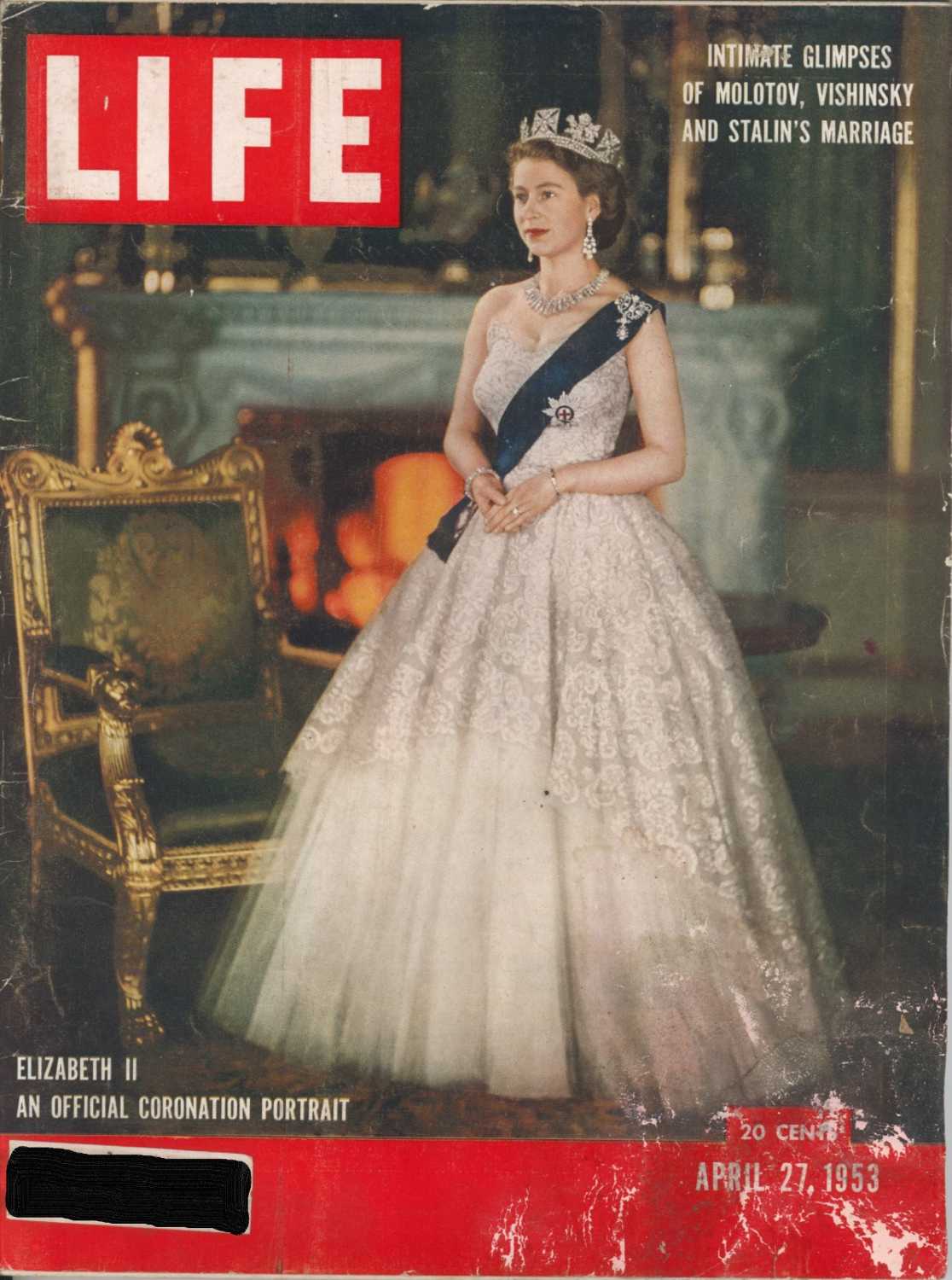 A coronation portrait of Queen Elizabeth II on the cover of Life Magazine. She is wearing a diamond studded crown, diamond earrings and necklace, and a blue sash. She is dressed in a white, strapless dress with a sweetheart neckline. The top of the dress is lace and the bottom appears to be organza. The dress is ball gown style with a wide skirt.