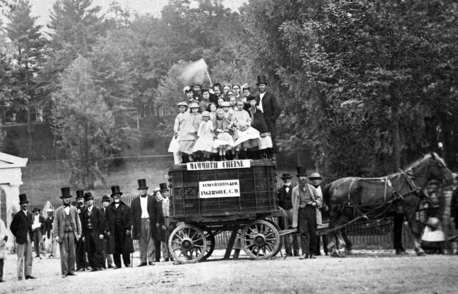 A group of people posing with a wagon filled with the famous 