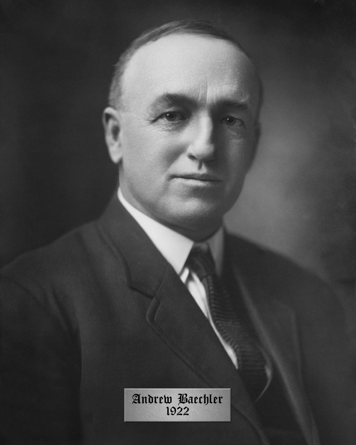 A portrait of County Warden Andrew Baechler. He is wearing a dark suit and tie and a white button down shirt.